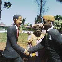 statue at Kogelo village resort painting a fictional meeting between Mama Sarah Obama, Barack and Luo political scion Raila Odinga.jpg