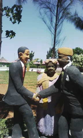 statue at Kogelo village resort painting a fictional meeting between Mama Sarah Obama, Barack and Luo political scion Raila Odinga.jpg