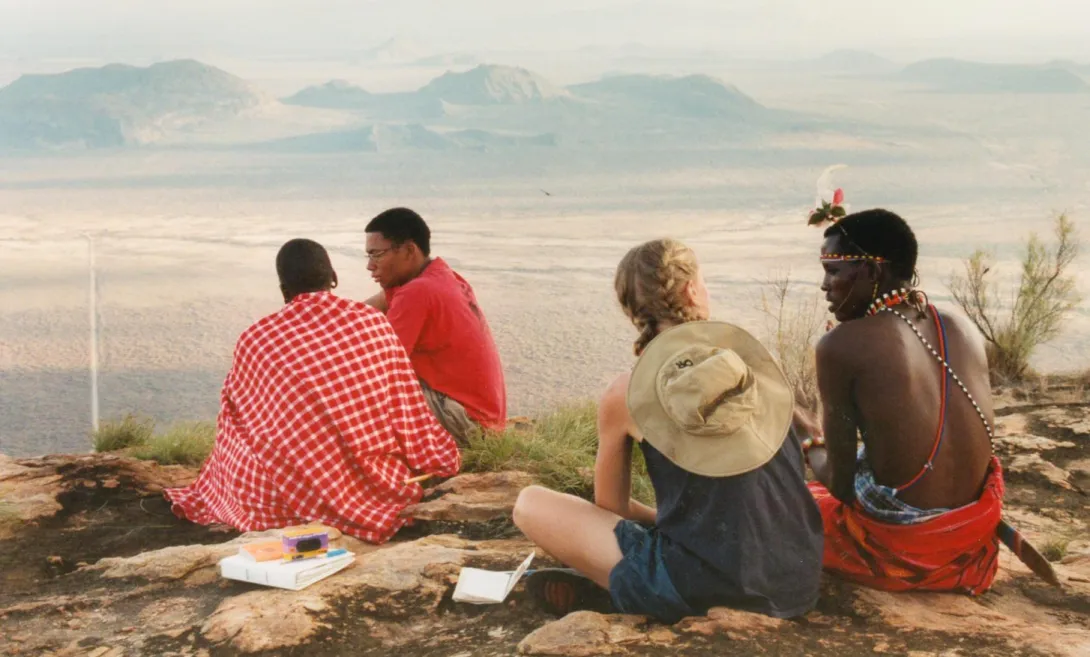 Two SLU students talking to two Kenyans in Kenya